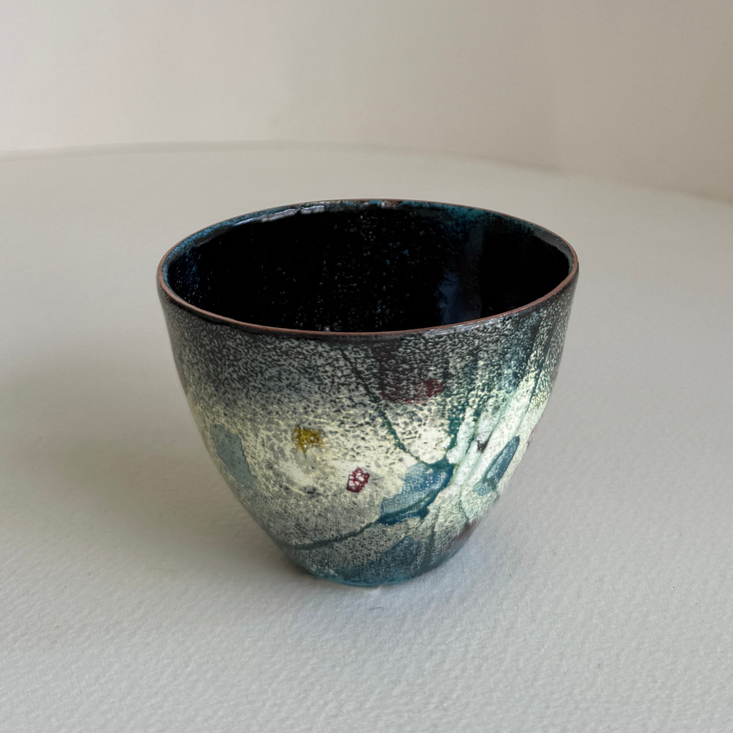 small decorative vessel in copper and enamel