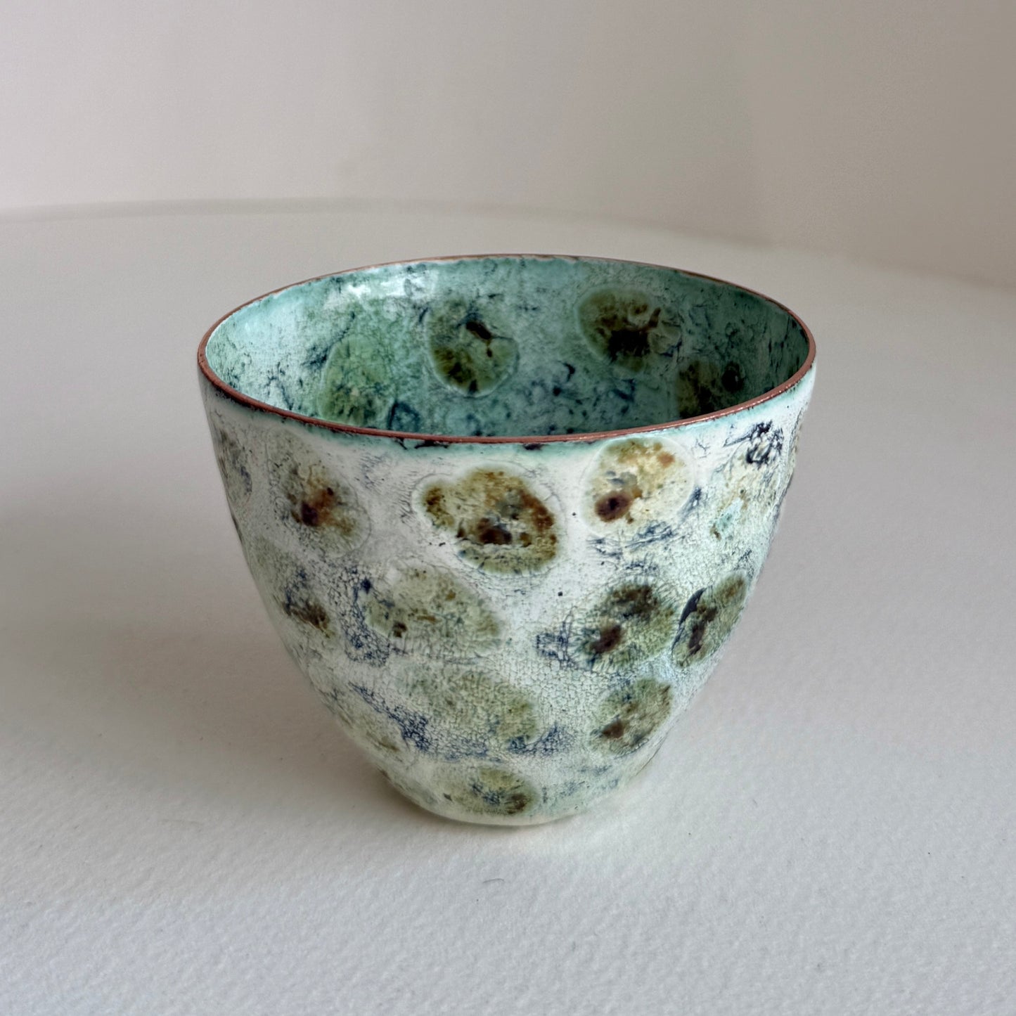 small decorative vessel in copper and enamel