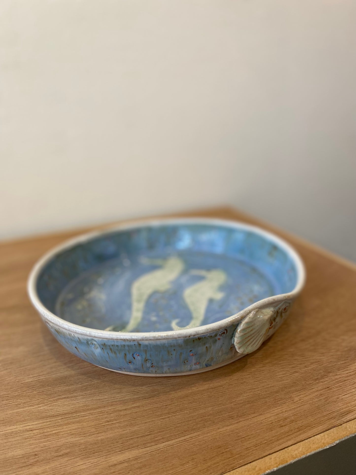 Deep rimmed serving platter with shell details