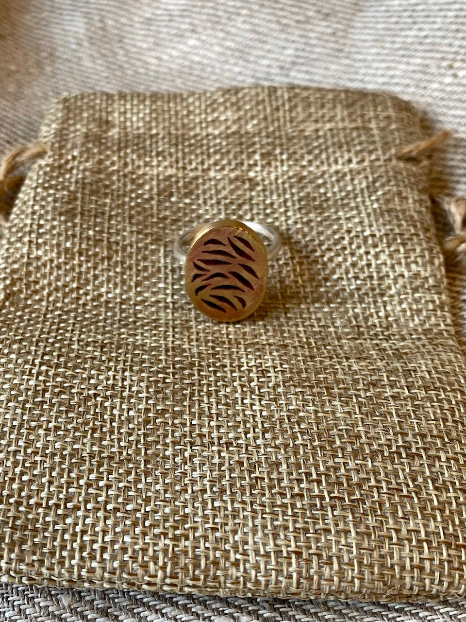 Pierced petals small oval ring, red brass top