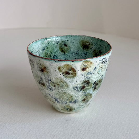 small decorative vessel in copper and enamel
