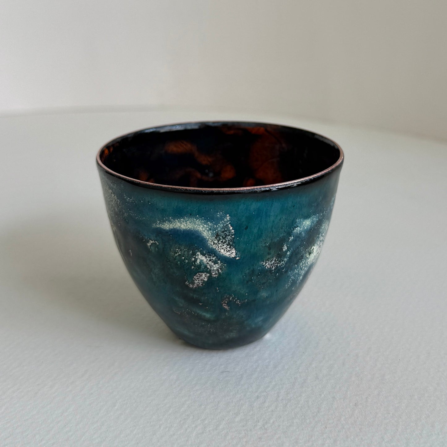 small decorative vessel in copper and enamel