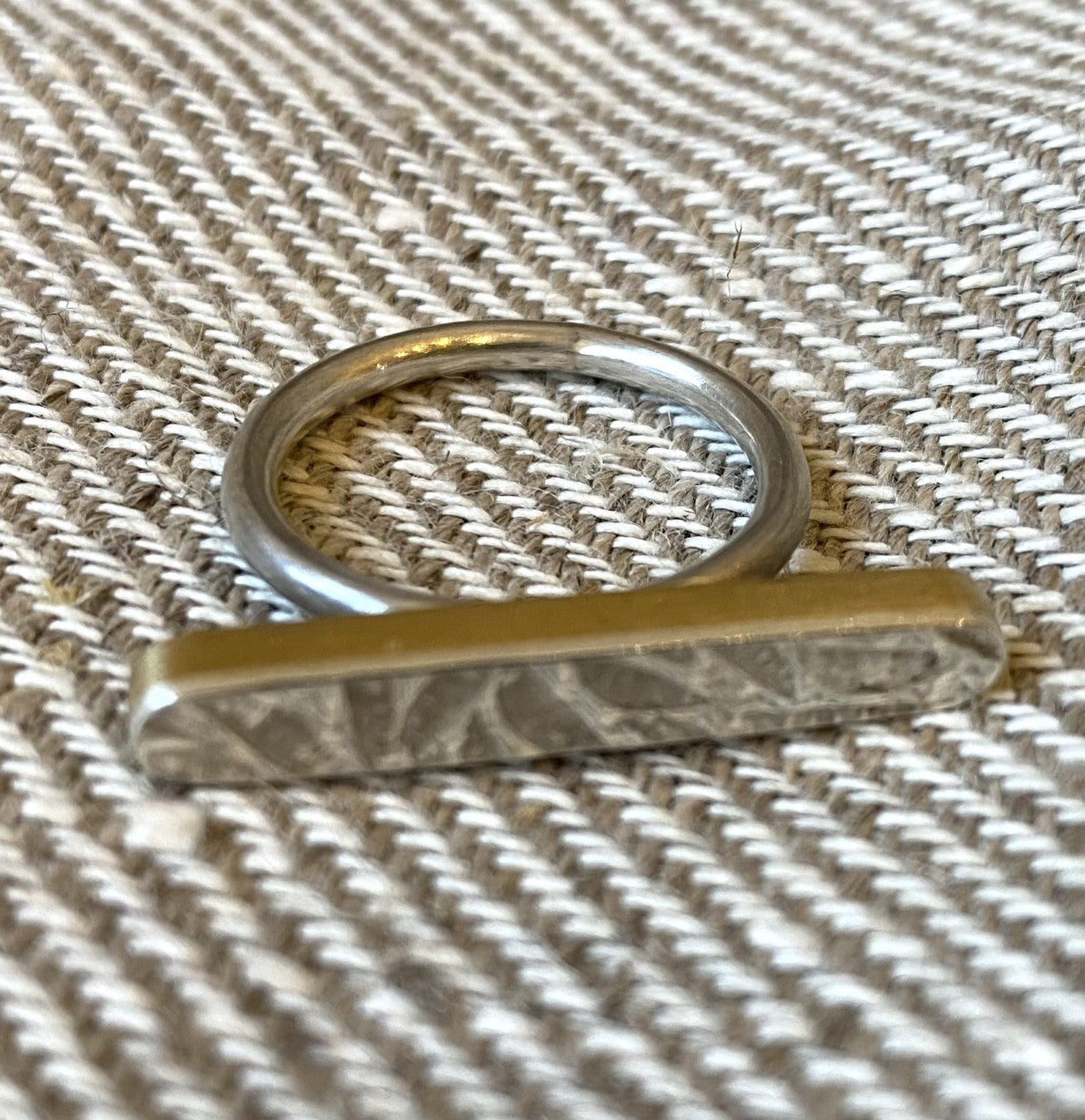 Across the bar ring silver with brass sides